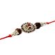 Auspicious Rudraksha with Silvr Cap Rakhi with Red-White Diamonds